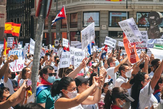 A vibrant street protest with diverse participants holding flags and placards, advocating for change.